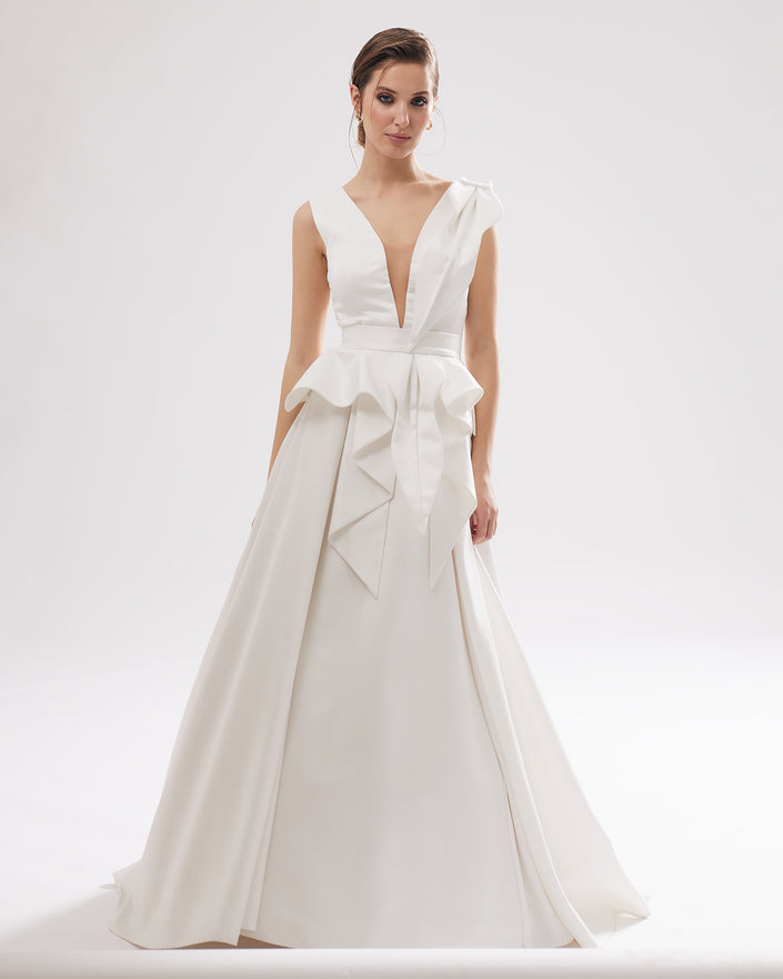 Unique wedding dress with a deep V-neckline, pleats and a petal motif