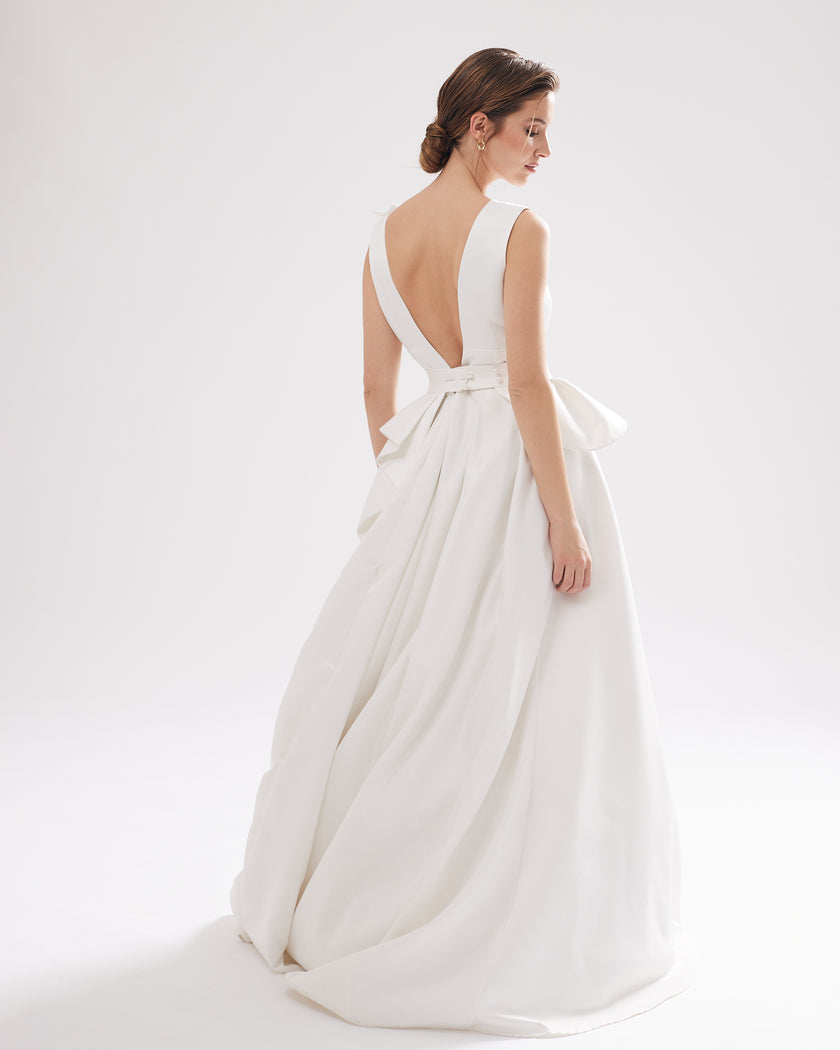 Unique wedding dress with a deep V-neckline, pleats and a petal motif