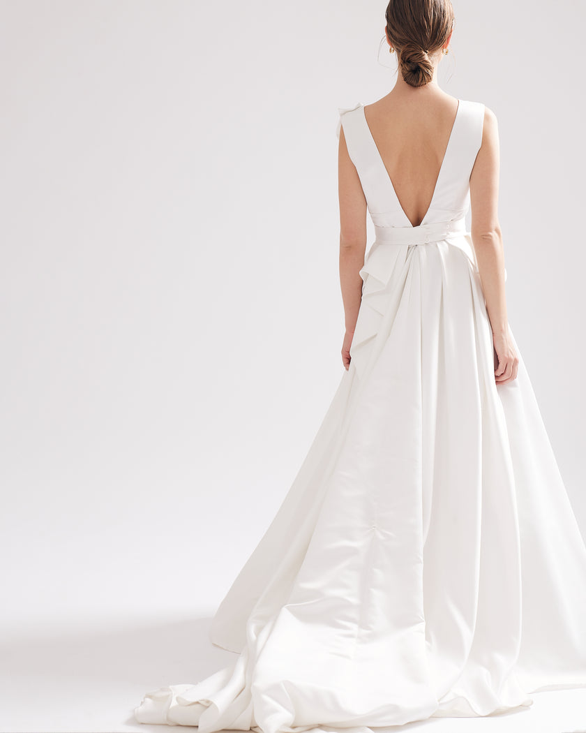 Unique wedding dress with a deep V-neckline, pleats and a petal motif
