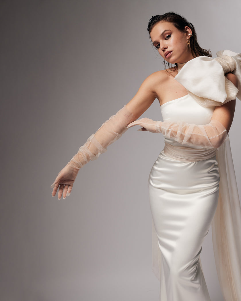 Unique mermaid cut wedding dress with neck detail and puff bow