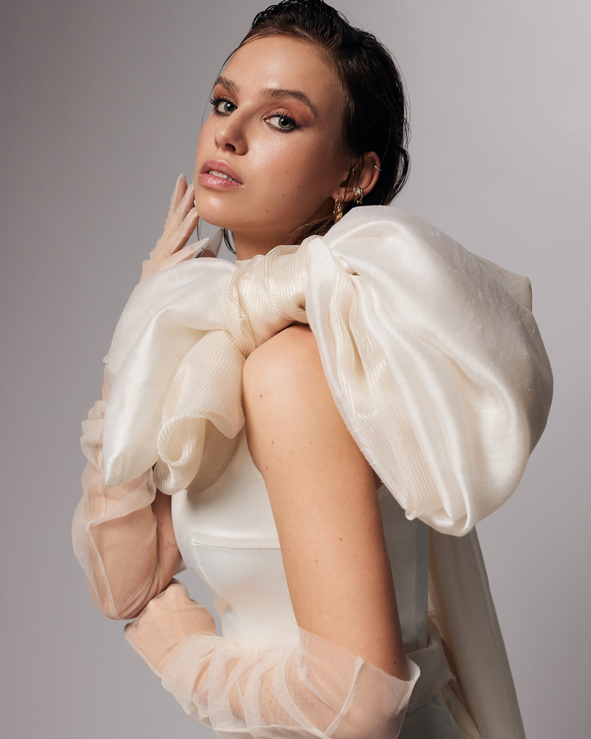 Unique mermaid cut wedding dress with neck detail and puff bow