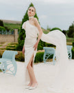 Elegant one-shoulder wedding dress with a train and a long bow