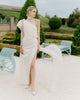Elegant one-shoulder wedding dress with a train and a long bow